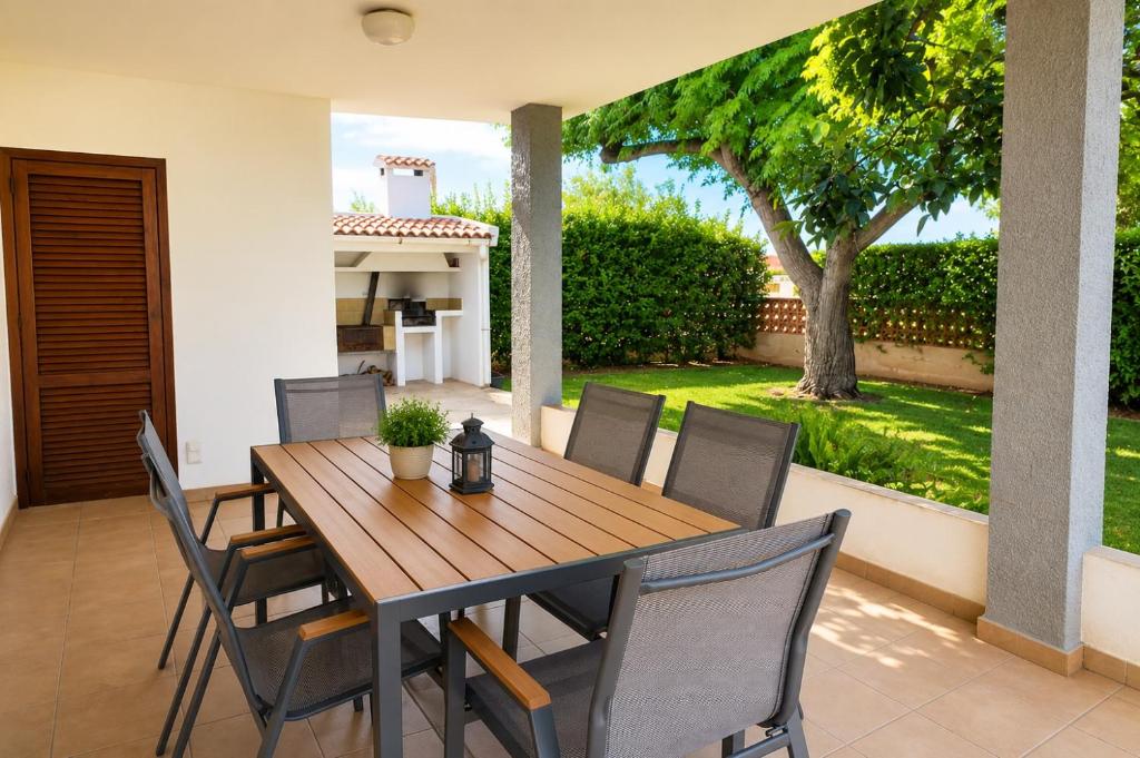a wooden table and chairs on a patio at Casa María in Vinarós