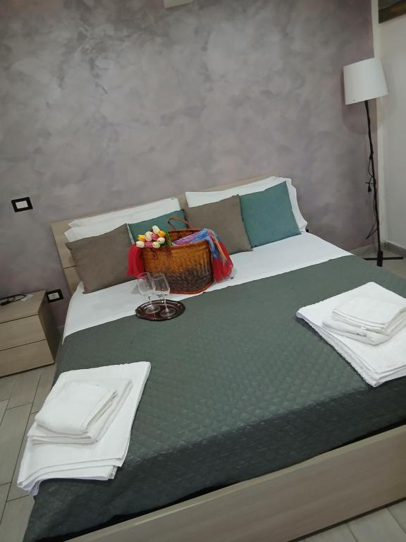 a bed with towels and a basket on top of it at La Dimora Di Bruna in Naples
