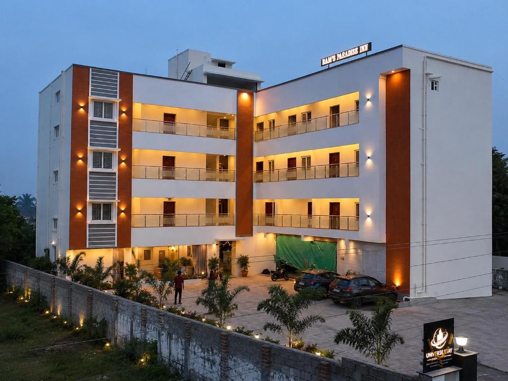 a building with a parking lot in front of it at Raja's Paradise Inn in Chennai