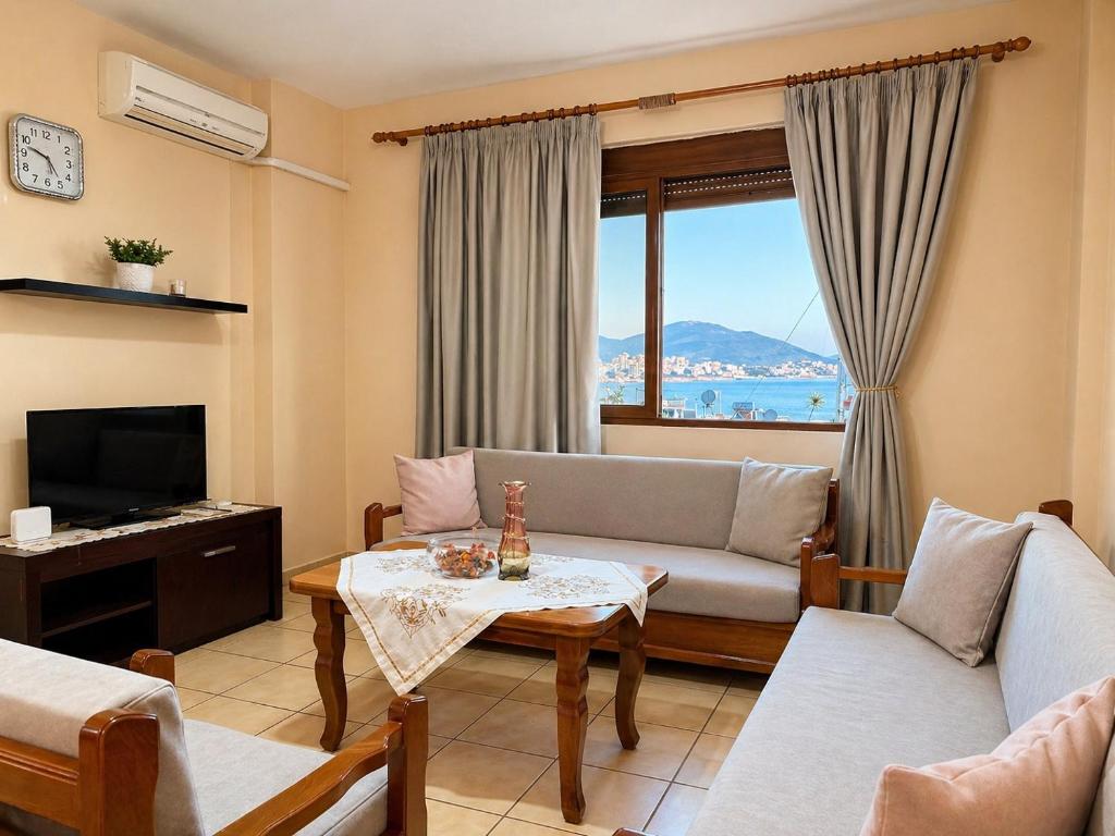 a living room with a couch and a table at Lana's Apartment in Sarandë