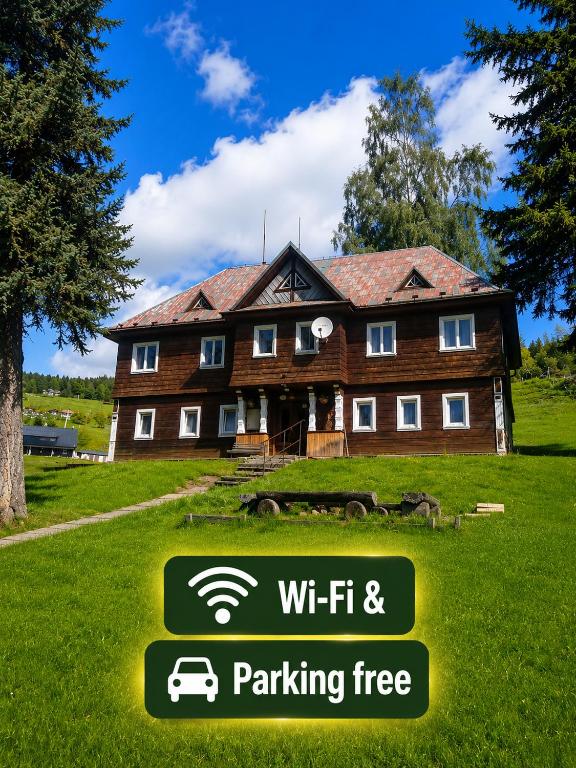 a building with a sign in front of it at Chata Jablunka, Dog friendly, 50m ski slope, 50m restaurant in Pec pod Sněžkou