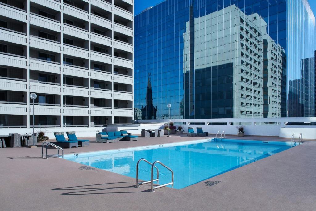a large swimming pool in front of a building at Delta Hotels by Marriott Winnipeg in Winnipeg