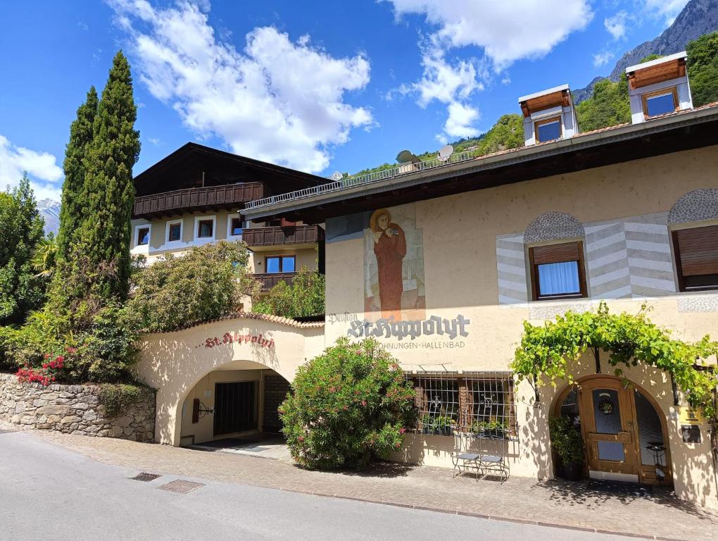 a building with a sign on the side of it at Ferienwohnungen St Hippolyt mit Hallenbad in Lagundo