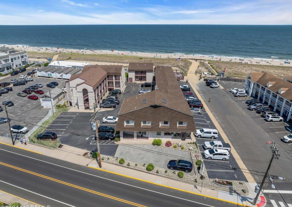 an aerial view of a building and parking lot next to the beach at Windswept Motel in Point Pleasant Beach