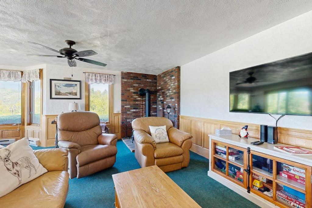 a living room with two chairs and a tv at Christmas Mountain Retreat in Bartlett
