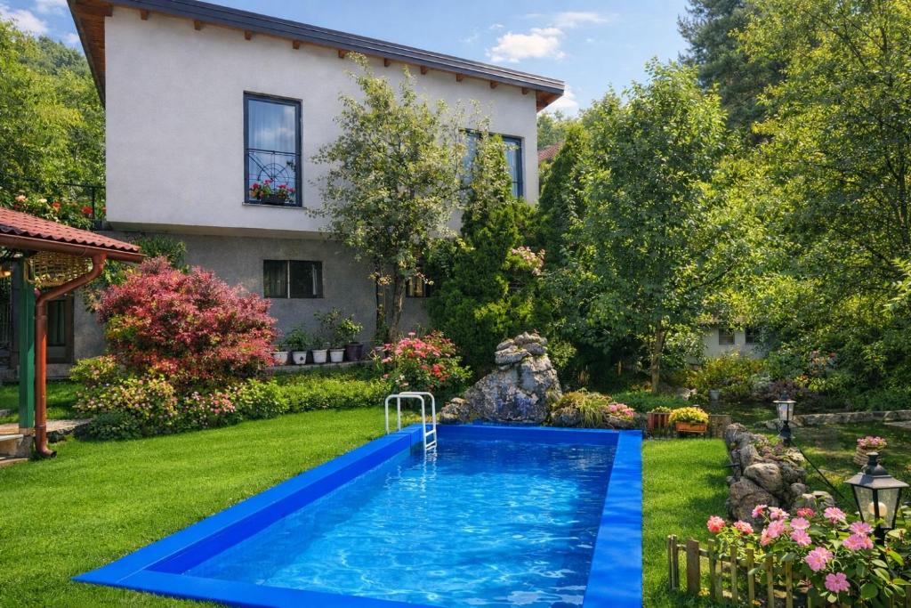 a swimming pool in the yard of a house at Sarajevo Hills-POOL&JACUZZI private garden Home-Near Old Town in Sarajevo