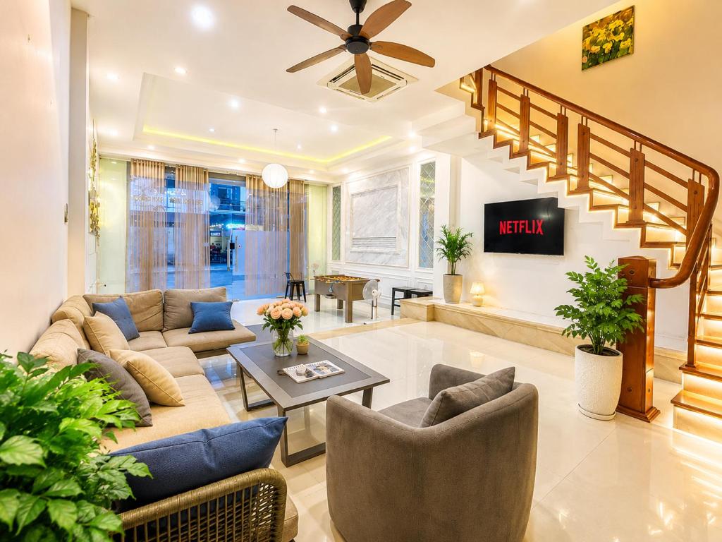 a living room with a couch and a table at Casa de LYN Nha Trang in Nha Trang