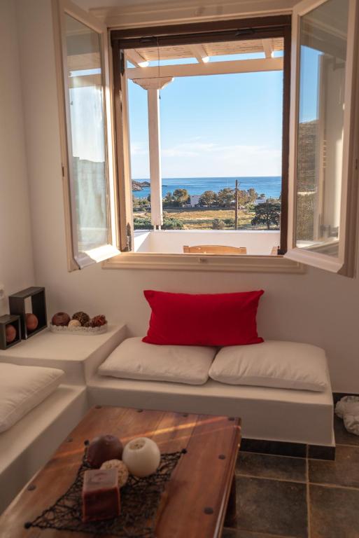 a living room with a couch and a large window at Mylopota apartment IV in Ios Chora
