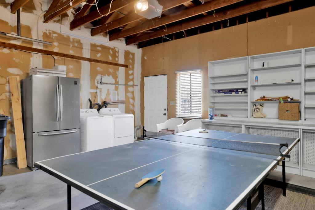 a ping pong table in a kitchen with a refrigerator at Big Bear Bungalow #643 in Big Bear City