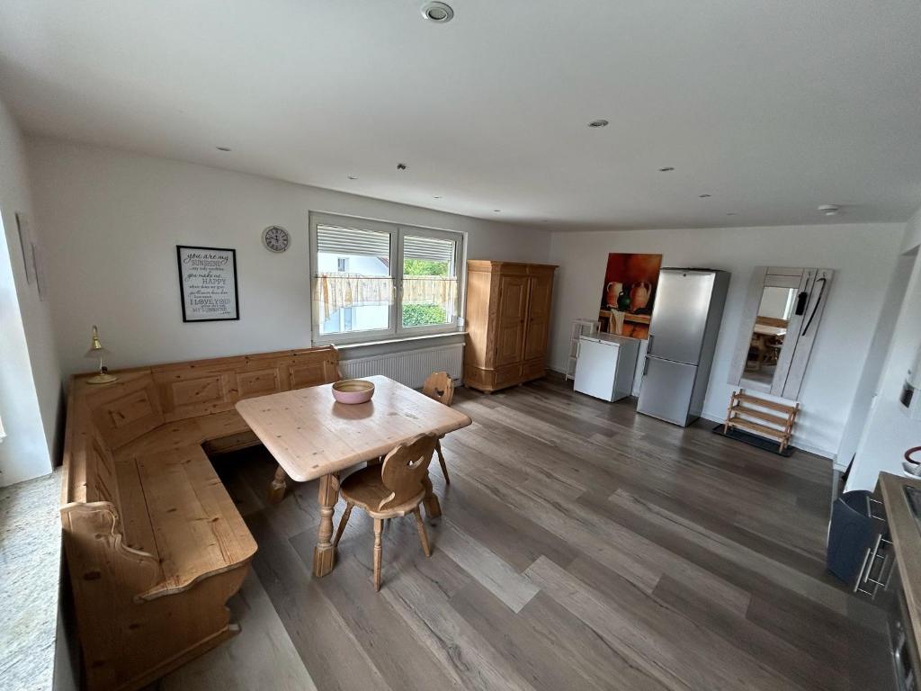a living room with a wooden table and a kitchen at Monteur-Ferienwohnung Julianna in Bad Staffelstein in Bad Staffelstein