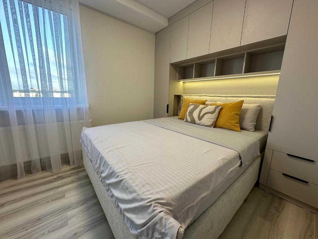 a bedroom with a large bed and a window at Home sweet home 2 in Chişinău