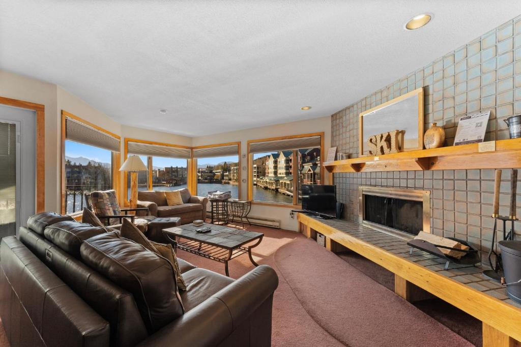 a living room with a couch and a fireplace at Willows #1713 in Keystone