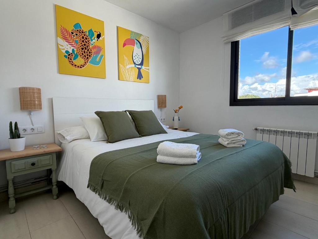 a bedroom with a bed and a desk and a window at Ático en Cubelles playa in Cubelles
