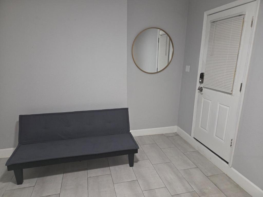 a black bench in a room with a mirror at Flawless one bedroom apartment! in Houston