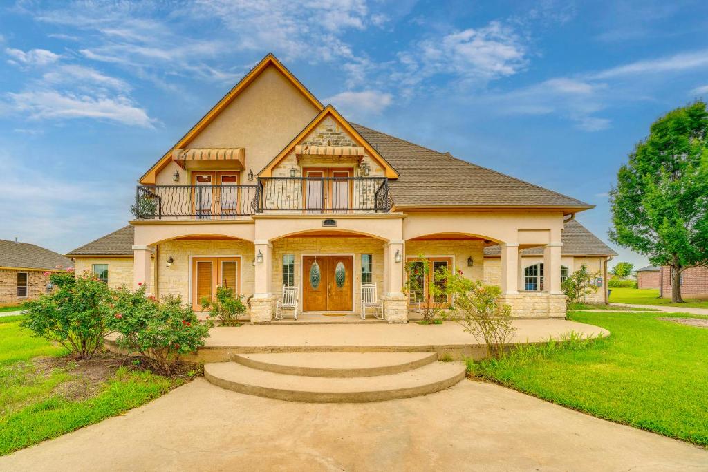 a house with a balcony on top of it at Red Oak Group Getaway w/ Yard + Patio in Red Oak