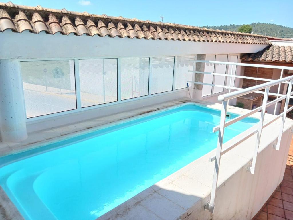 a swimming pool in a house with a window at Casa La Fuente in Chella