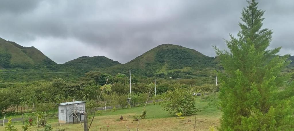 a view of a mountain range with a small shack at Finca LA HERMOSA in Guzmán
