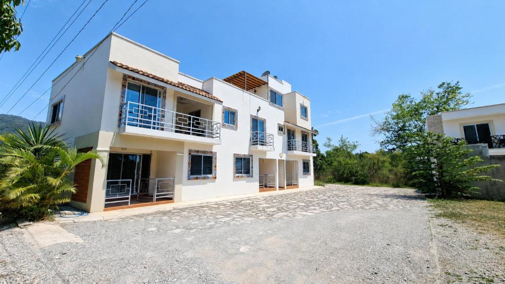 a view of a house with a driveway at Bungalows Huerta del Mar in San Blas