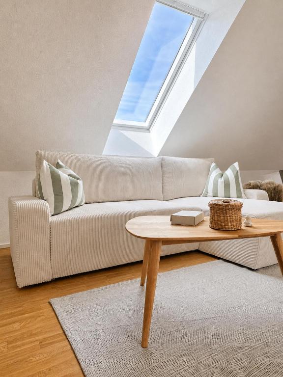 a living room with a couch and a table at All Homes Apartments Bad Schallerbach in Bad Schallerbach