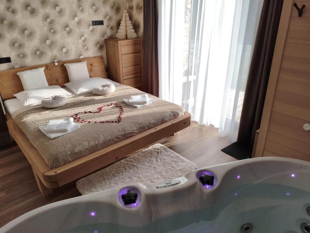 a bedroom with a bed and a bath tub at Srnčí vrch in Batňovice