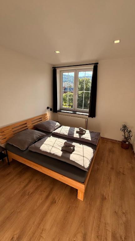 a large bed in a room with a window at Apartmány Pod Stráží in Sušice