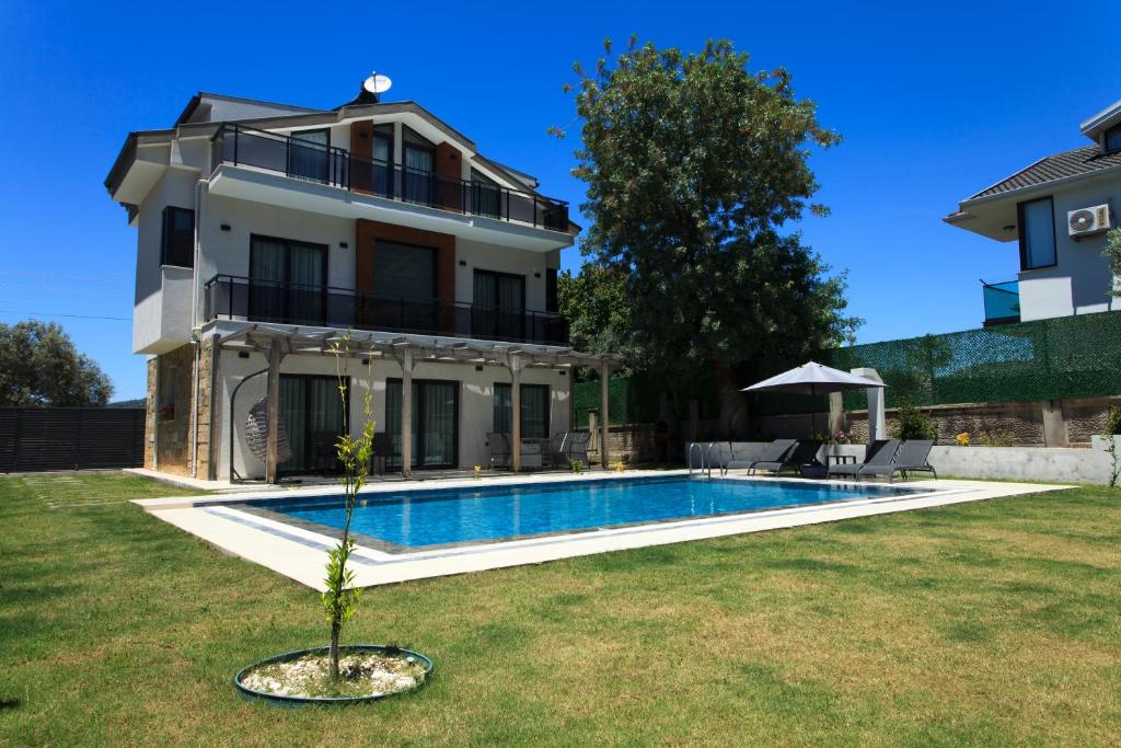 a house with a swimming pool in the yard at Cesur Villa in Fethiye