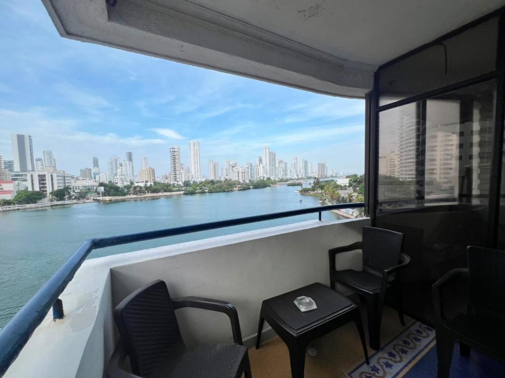 a balcony with chairs and a view of a river at aprtamento CTG in Cartagena de Indias
