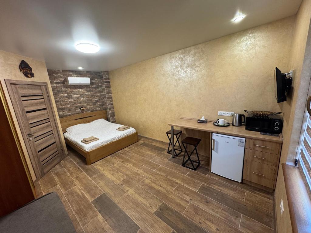 a small room with a bed and a small table at Тихий дворик in Odesa