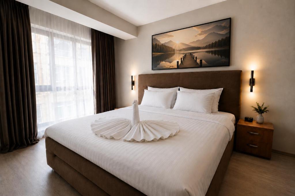 a bedroom with a large white bed with a large window at Astryn Aparthotel 9 SELF CHECK-IN #Otopeni #Airport #Therme #Bucharest in Otopeni
