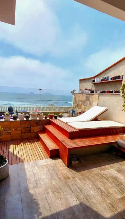 a balcony with benches and a view of the ocean at Spacious 4BR Duplex with Pool in Punta Hermosa in Punta Hermosa