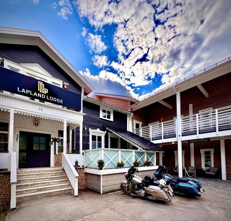 a couple of motorcycles parked outside of a building at Lapland Lodge in Arvidsjaur
