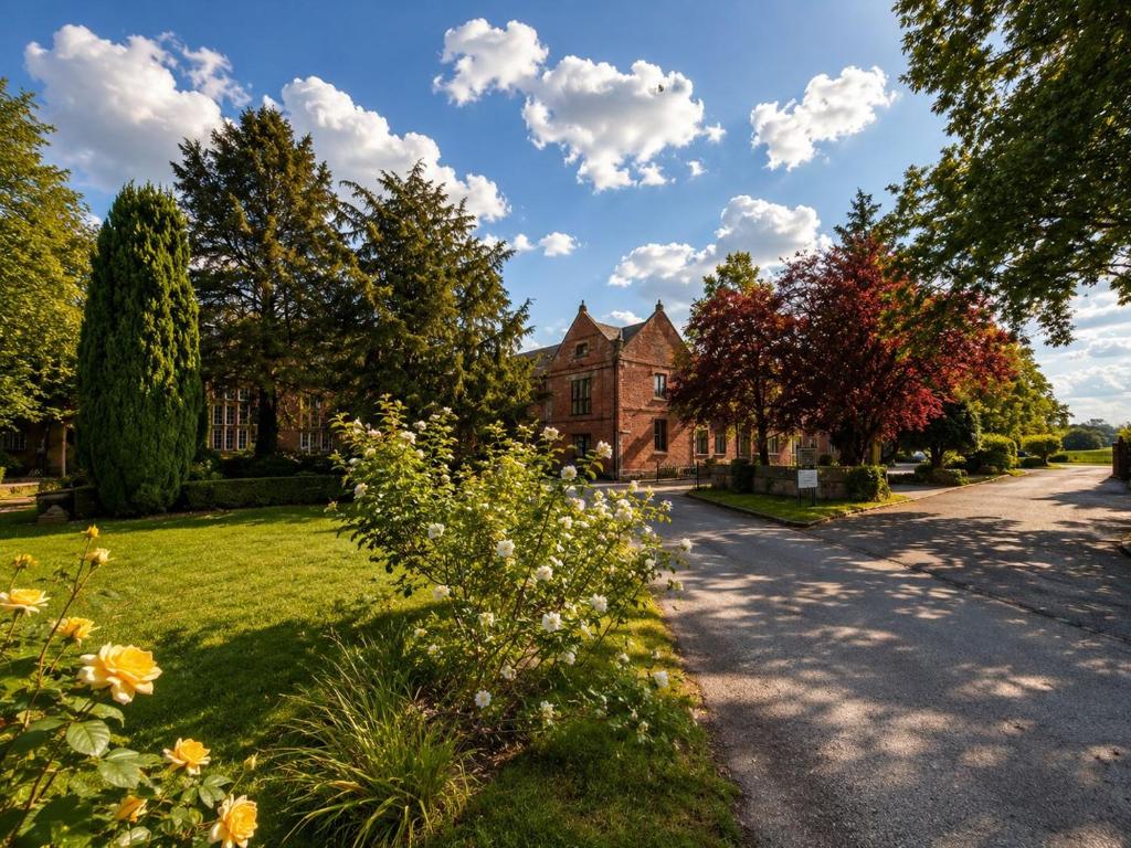 a house with trees and flowers in front of a road at Primrose Manor in Risley
