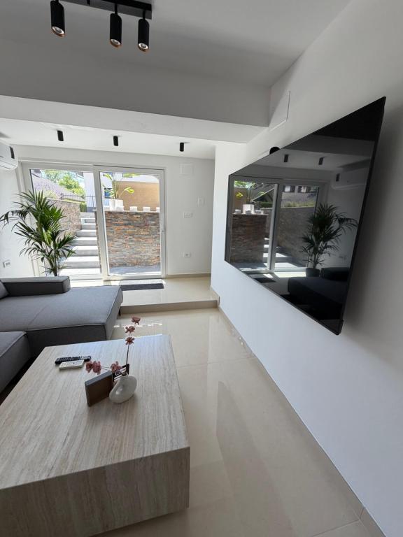 a living room with a couch and a table at Ana Deluxe Apartment in Radovljica