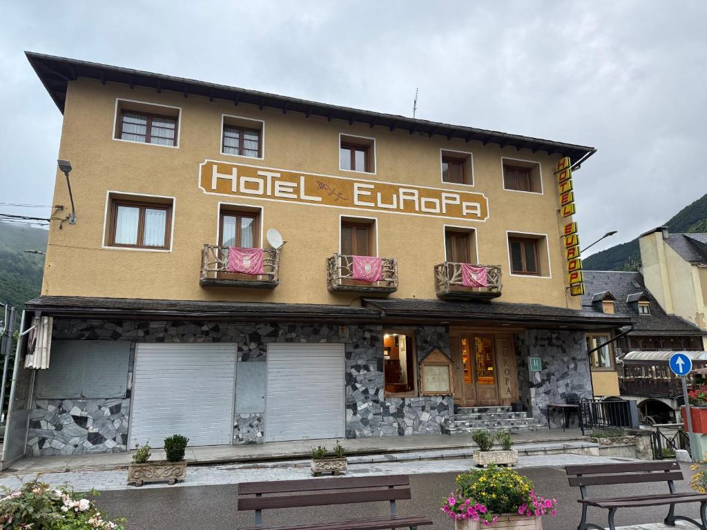 a building with benches in front of it at Hotel Europa Les by Dynamic Hotels in Les