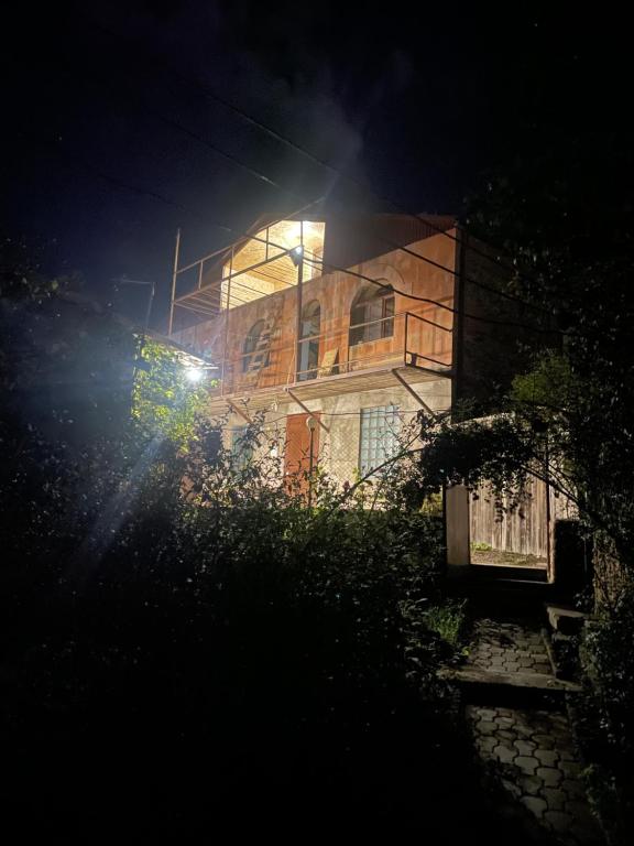 a building with a light on top of it at night at Aygut Garden in Aygut