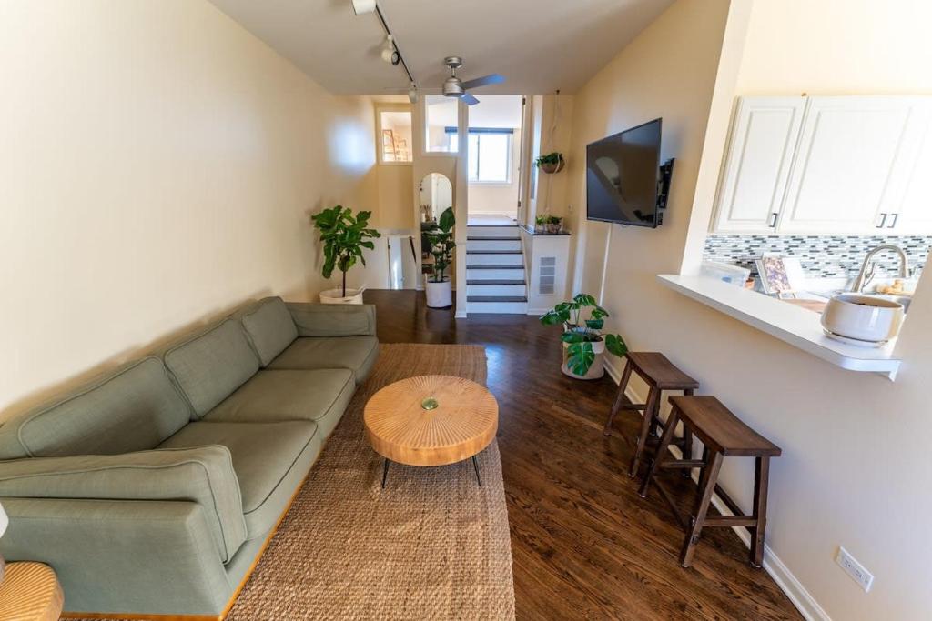 a living room with a couch and a table at Bucktown Private Condo in Chicago