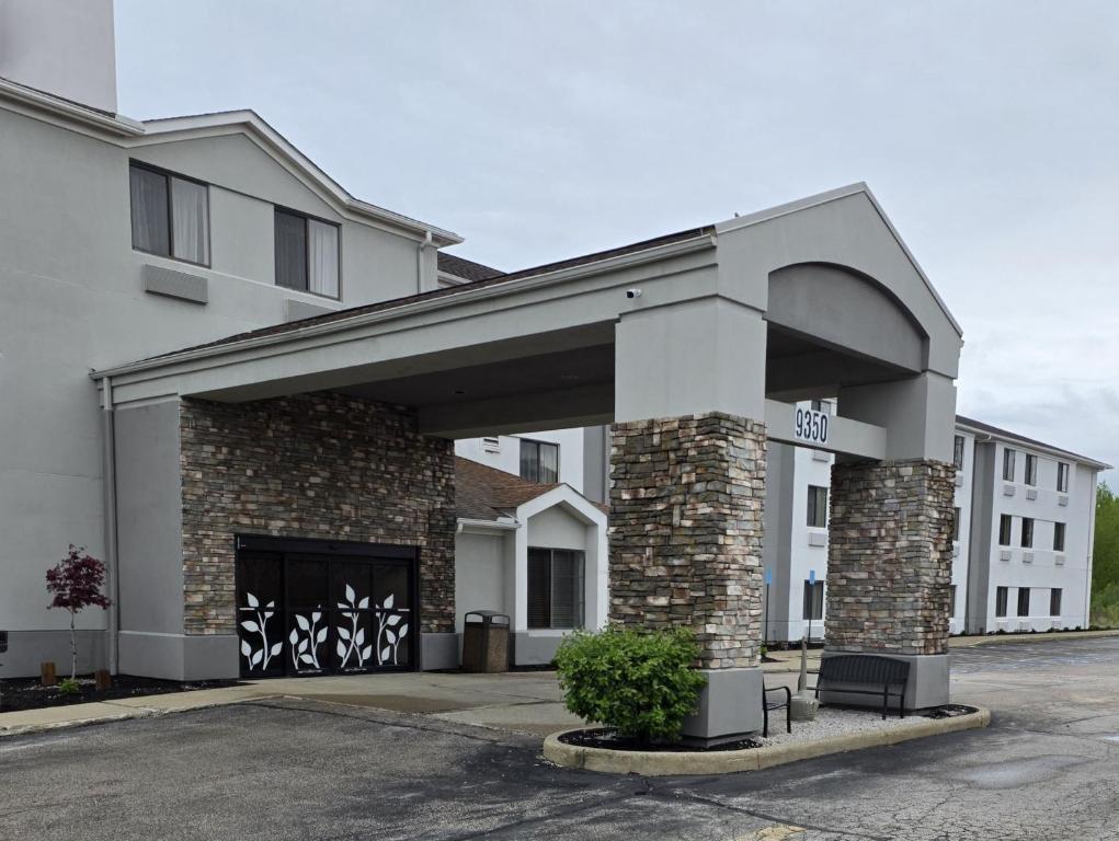a building with a parking lot with a garage at Austinburg Hotel in Austinburg