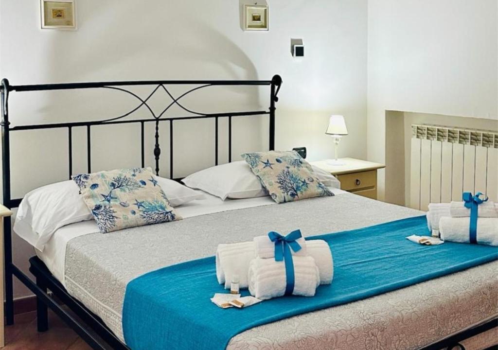 a bedroom with a bed with towels on it at Near Acquamorta Beach - Villa Lamberti Casa Sole in Monte di Procida
