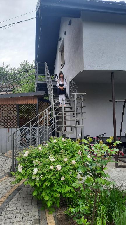 a woman standing on the stairs of a building at Garage Home in Yaremche