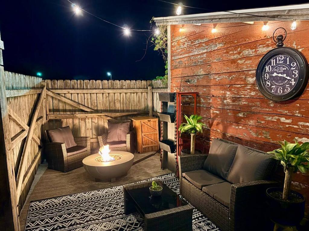 a patio with a couch and a clock on a brick wall at Riverbend Suite - Potter’s Mill in Bellevue