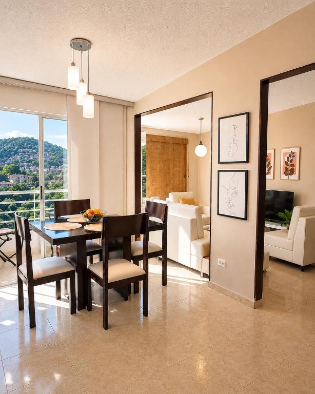 a dining room with a table and chairs and a living room at Espectacular! Apartamento en cali cerca al coliseo del pueblo in Cali