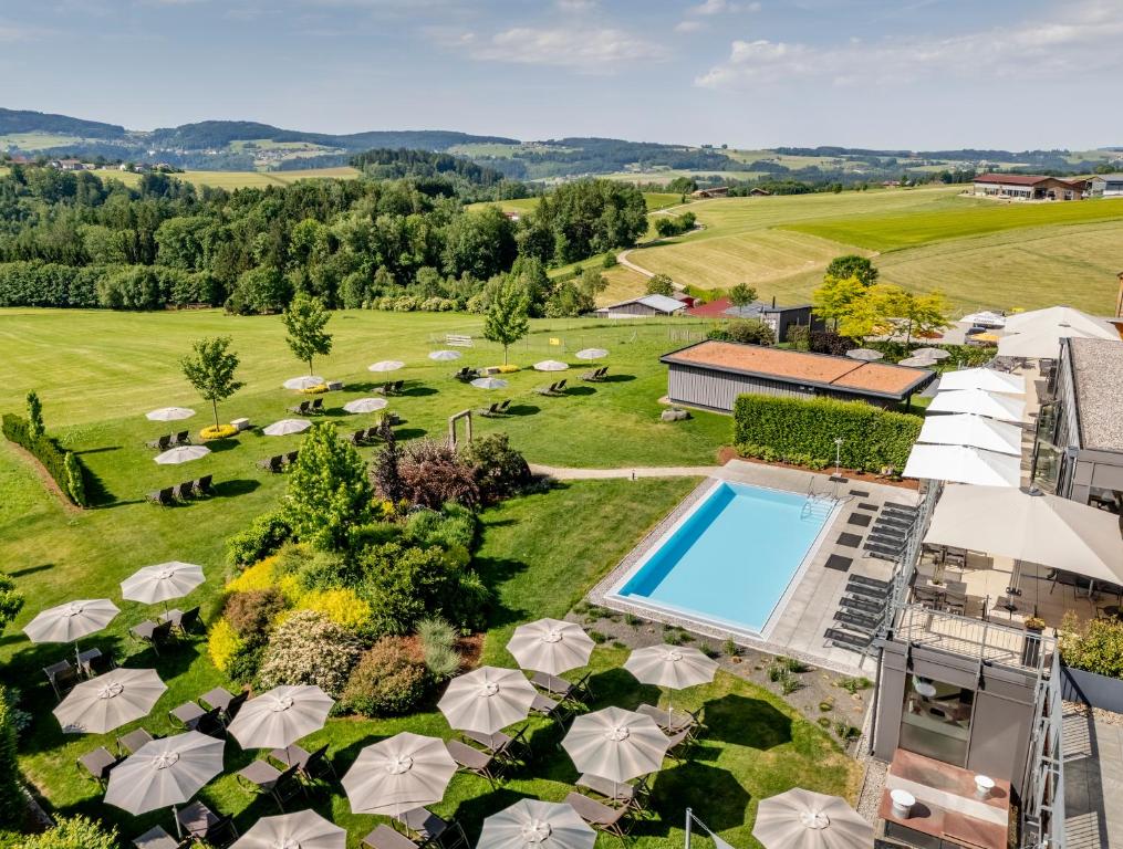 an aerial view of a garden with a swimming pool and umbrellas at Landrefugium Obermüller 4,5 Sterne in Untergriesbach
