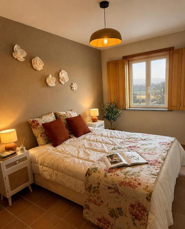 a bedroom with a bed with a book on it at Iconic Vila d'Obidos in Óbidos