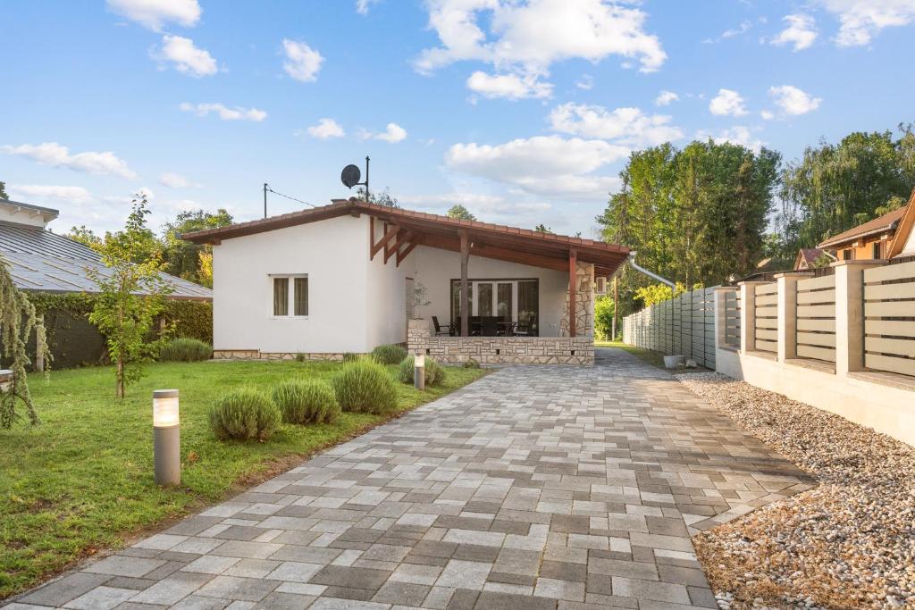 a house with a pathway leading to a house at Gery Apartman in Zamárdi