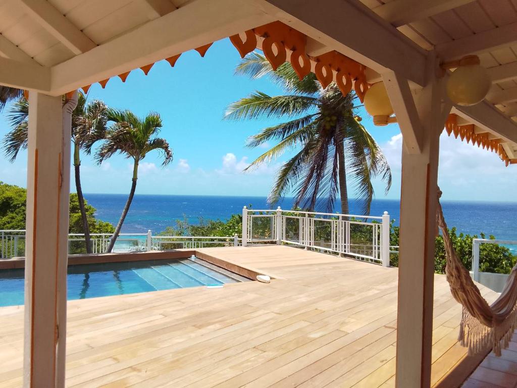 a view from the deck of a house with a swimming pool at Villa Vue Océan in Le Moule