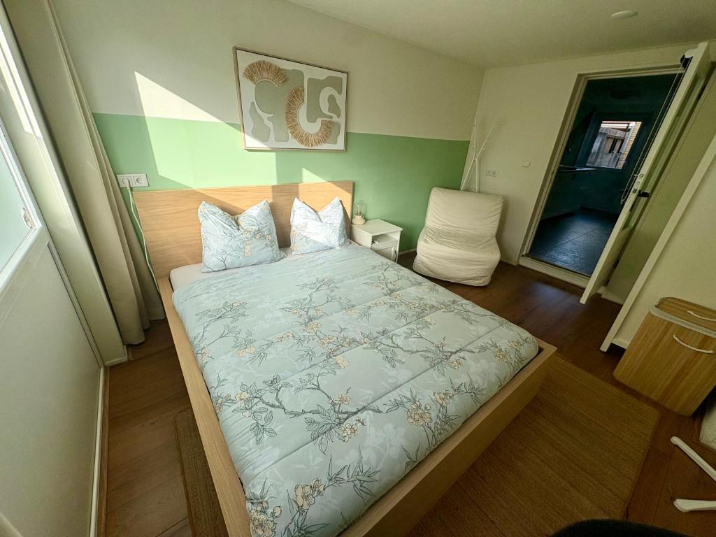 a bedroom with a large bed in a room at The Sleep Studio in Sint Annaland