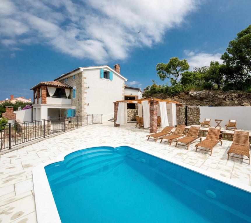 an image of a villa with a swimming pool at Villa Copun with heated pool in Rab