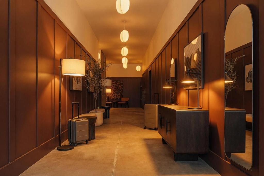 a bathroom with a long hallway with sinks and mirrors at Ceros in Denver