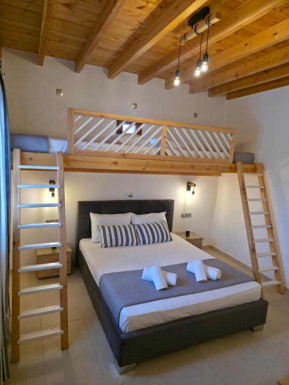a bedroom with a bunk bed and two bunk beds at Villa Natural View in Moutsoúna