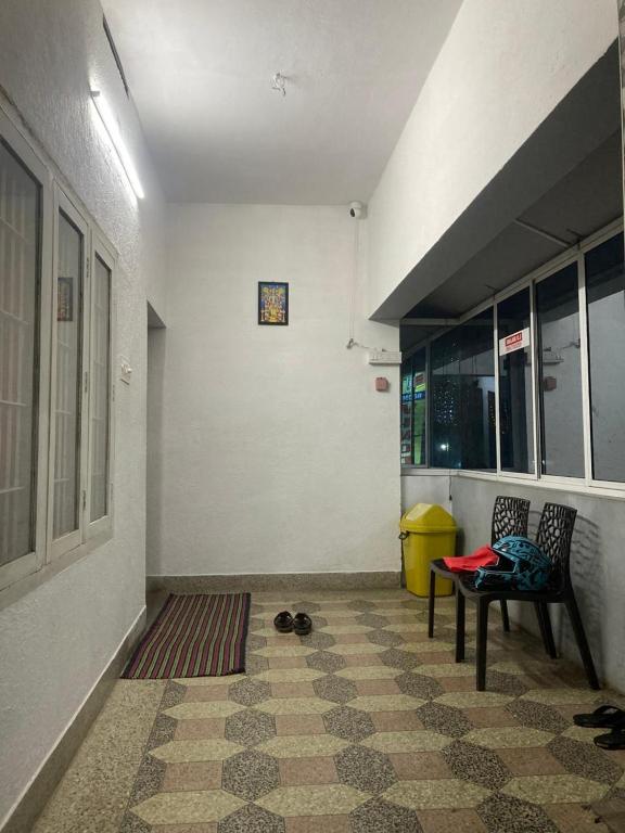 a hallway with a table and chairs in a building at sree thilak apartments in Guruvāyūr